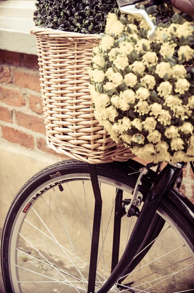 Close up on street bicycle with basket of flowers