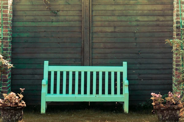 White Wooden garden bench in English garden, retro color filter applied — Stock Photo, Image