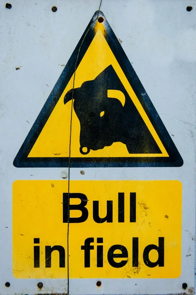 Warning sign of bull in the field, color filter applied — Stock Photo, Image