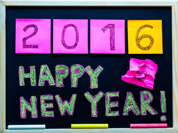 Happy New Year 2016 message hand written on blackboard, numbers stated on post-it notes, 2016 replacing 2015, corporate office celebration concept — Stock Photo, Image