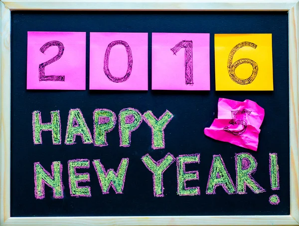 Happy New Year 2016 message hand written on blackboard, numbers stated on post-it notes, 2016 replacing 2015, corporate office celebration concept — Stock Photo, Image