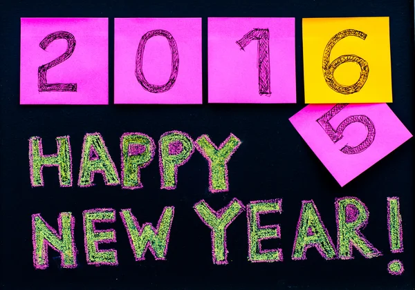 Happy New Year 2016 message hand written on blackboard, numbers stated on post-it notes, 2016 replace 2015, corporate office celebration concept — Stok Foto