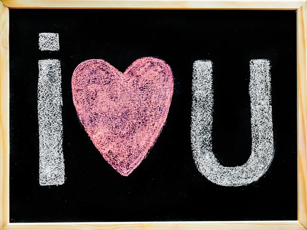 I love you message hand written with chalk on blackboard, word love replaced by heart shape, love concept — Stock Photo, Image