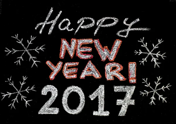 Feliz año nuevo 2017, escritura a mano con tiza en pizarra, aislado sobre fondo negro, concepto vintage — Foto de Stock