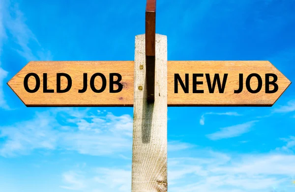 Wooden signpost with two opposite arrows over clear blue sky, Old Job and New Job, Career change conceptual image — Stock Photo, Image