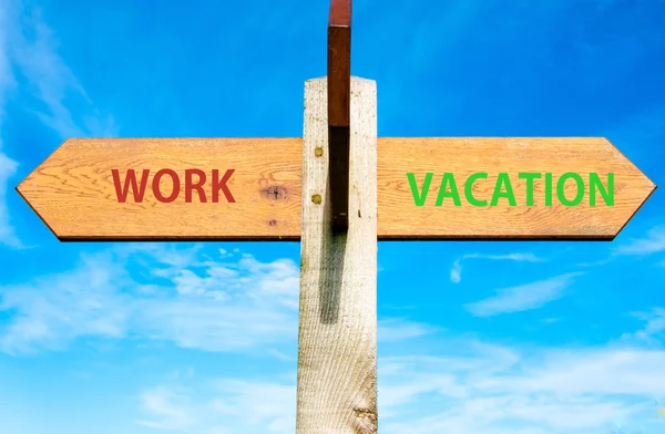 Houten wegwijzer met twee tegengestelde pijlen over de heldere blauwe hemel, werk en vakantie tekenen, Work Life Balance conceptuele afbeelding — Stockfoto