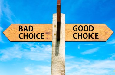 Wooden signpost with two opposite arrows over clear blue sky, Bad Choice and Good Choice messages, Right choice conceptual image clipart