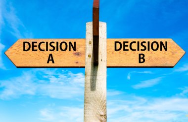 Wooden signpost with two opposite arrows over clear blue sky, Decision A and Decision B messages, Right choice conceptual image clipart