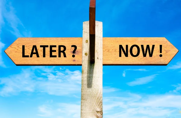 Wooden signpost with two opposite arrows over clear blue sky, Later versus Now messages, Lifestyle change conceptual image — Stock Photo, Image