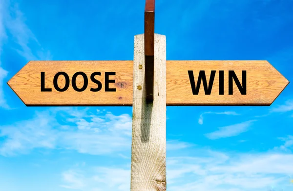 Wooden signpost with two opposite arrows over clear blue sky, Loose versus Win messages, Lifestyle change conceptual image — Stock Photo, Image