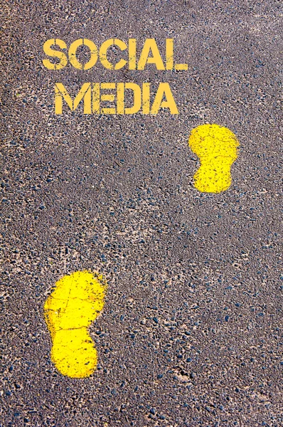 Yellow footsteps on sidewalk towards Social Media message — Stock Photo, Image