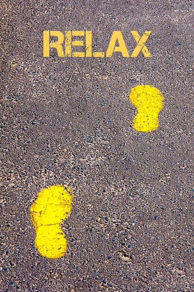 Yellow footsteps on sidewalk towards Relax message — Stock Photo, Image