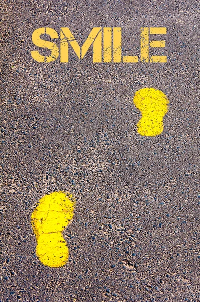 Yellow footsteps on sidewalk towards Smile message — Stock Photo, Image