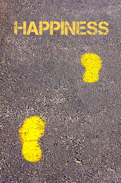 Yellow footsteps on sidewalk towards Happiness message — Stock Photo, Image