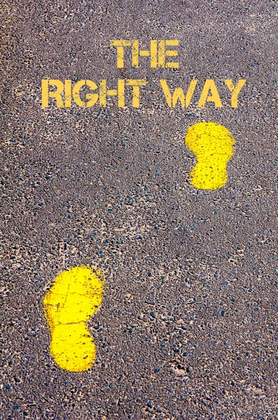 Yellow footsteps on trowalk towards The Right Way message — стоковое фото