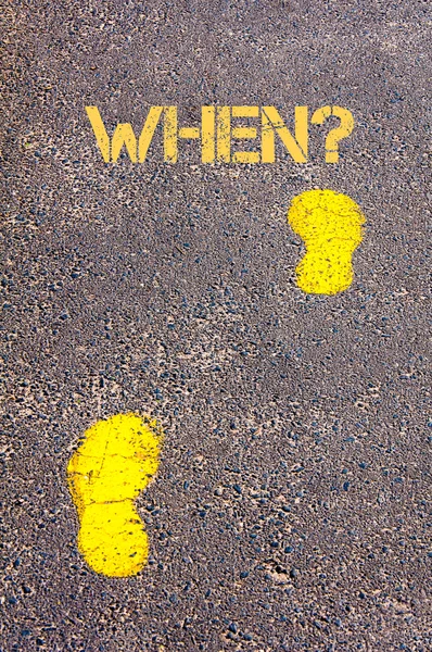 Yellow footsteps on sidewalk towards When message — Stock Photo, Image