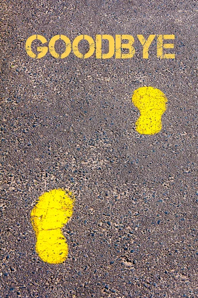 Yellow footsteps on sidewalk towards Goodbye message — Stock Photo, Image