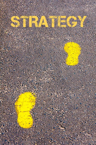 Yellow footsteps on trowalk towards Strategy message — стоковое фото