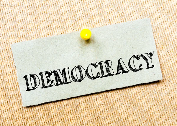 Recycled paper note pinned on cork board.Democracy Message — Stock Photo, Image