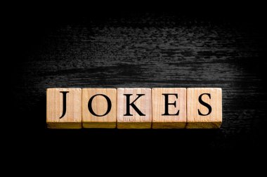 Word JOKES isolated on black background with copy space clipart
