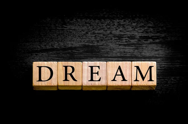 Word DREAM isolated on black background with copy space — Stock Photo, Image