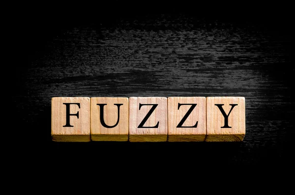 Word FUZZY isolato su sfondo nero con spazio di copia — Foto Stock