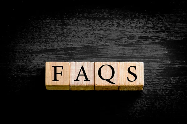 Word FAQS isolated on black background with copy space — Stock Photo, Image