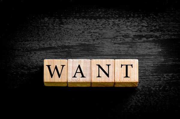 Word WANT изолирован на чёрном фоне с пространством для копирования
