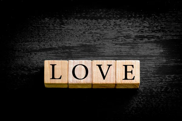 Word LOVE isolated on black background with copy space — Stock Photo, Image