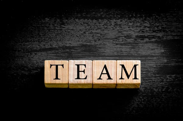 Word TEAM isolated on black background with copy space — Stock Photo, Image