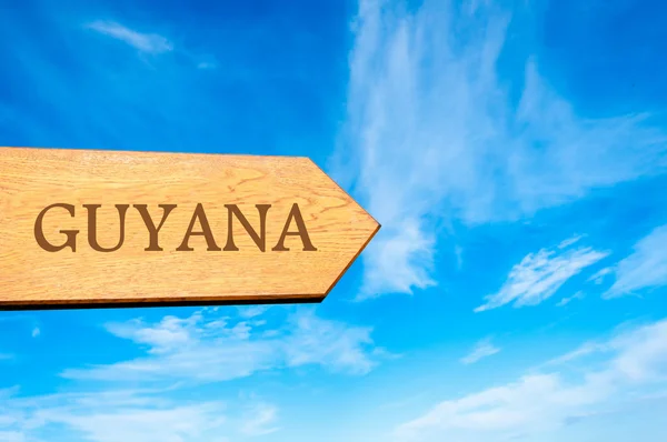 Wooden arrow sign pointing destination GUYANA — Stock Photo, Image