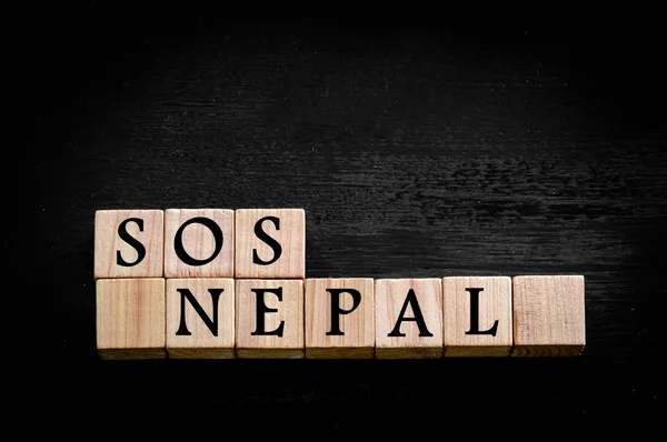 Message SOS NEPAL isolated on black background — Stock Photo, Image