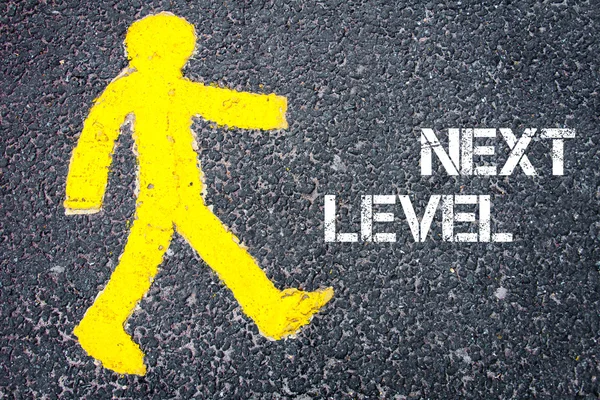 Figura peatonal amarilla caminando hacia NEXT LEVEL —  Fotos de Stock
