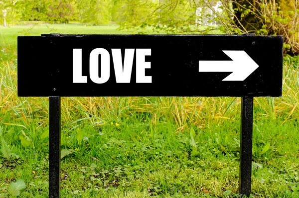 LOVE written on directional black metal sign — Stock Photo, Image