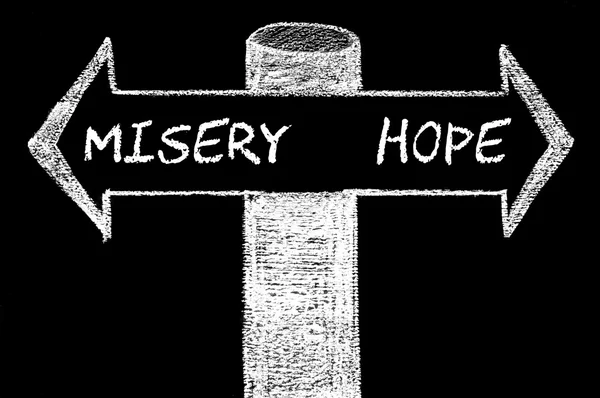 Opposite arrows with Misery versus Hope — Stock Photo, Image