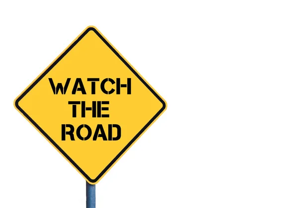 Желтый дорожный знак с сообщением Watch The Road — стоковое фото
