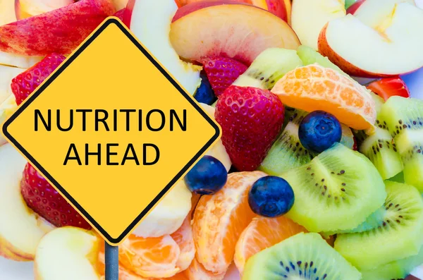 Yellow roadsign with message NUTRITION AHEAD — Stockfoto