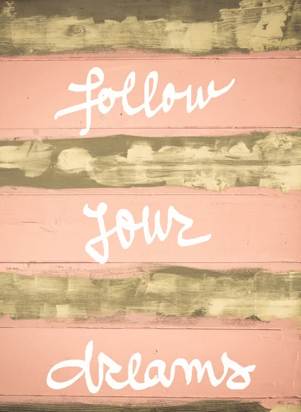 Imagem de conceito de Siga seus sonhos citação motivacional mão escrita na parede de madeira pintada vintage — Fotografia de Stock