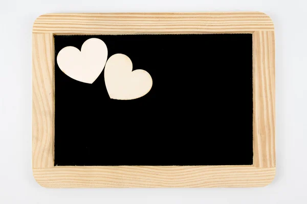 Vintage bord met houten frame geïsoleerd op wit, ambachtelijke hart vormen in de hogere linkerhoek — Stockfoto