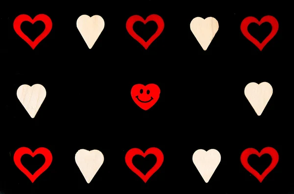 Heart shapes symbols and smiling emoticon isolated on black, available copy space, love concept — Stock Photo, Image