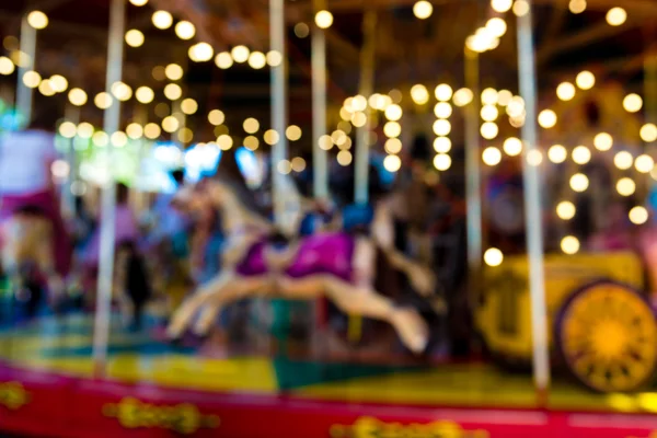 Blurred defocused background of traditional fairground vintage carousel — Stock Photo, Image