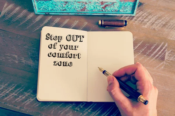 Motivational message STEP OUT OF YOUR COMFORT ZONE written on notebook — 스톡 사진
