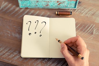 Motivational concept with handwritten THREE QUESTION MARKS