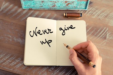 Motivational concept with handwritten text NEVER GIVE UP
