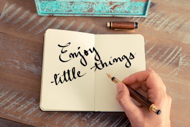 Motivational concept with handwritten text ENJOY LITTLE THINGS