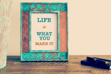 Motivational quote written on vintage photo frame 