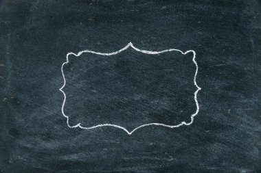 Hand drawing chalk frame on blackboard