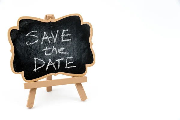 Wooden easel mini blackboard, text SAVE THE DATE — Stock Photo, Image