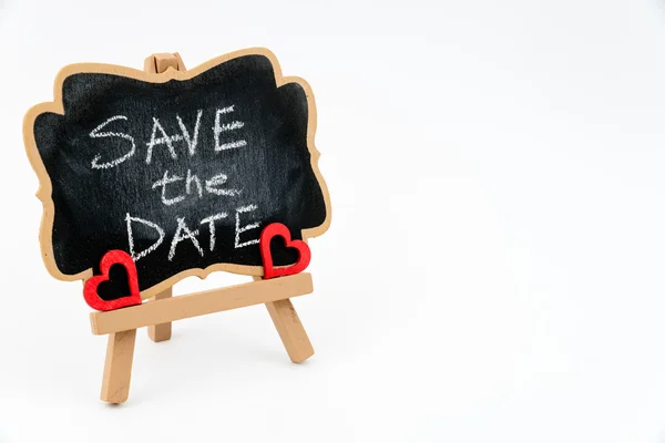 Wooden easel mini blackboard, text SAVE THE DATE — Stock Photo, Image