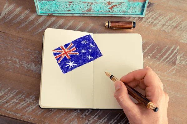女性手にノートにオーストラリアの旗を描画 — ストック写真